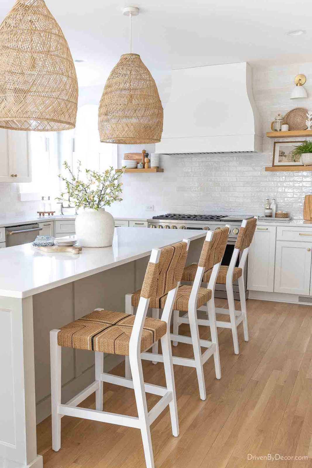 Pair of rattan bell pendants over kitchen island