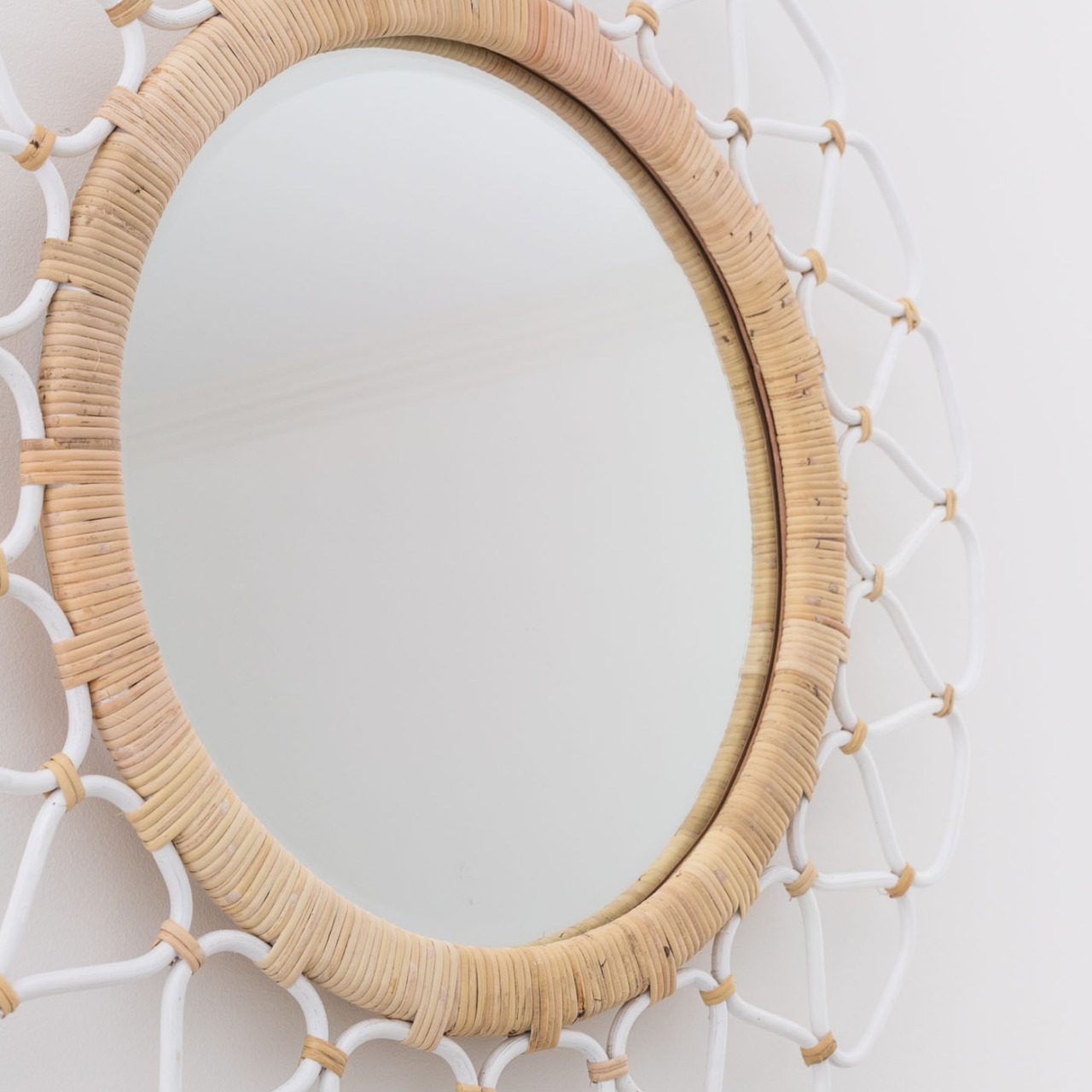 Love this rattan mirror that she put above the bed!