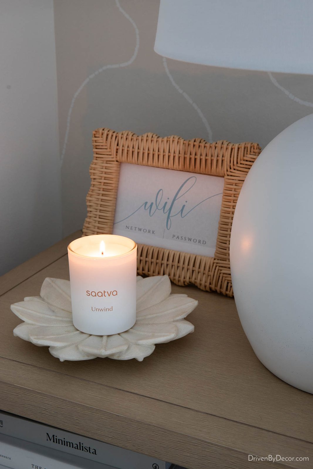 Lighted Saatva candle on nightstand