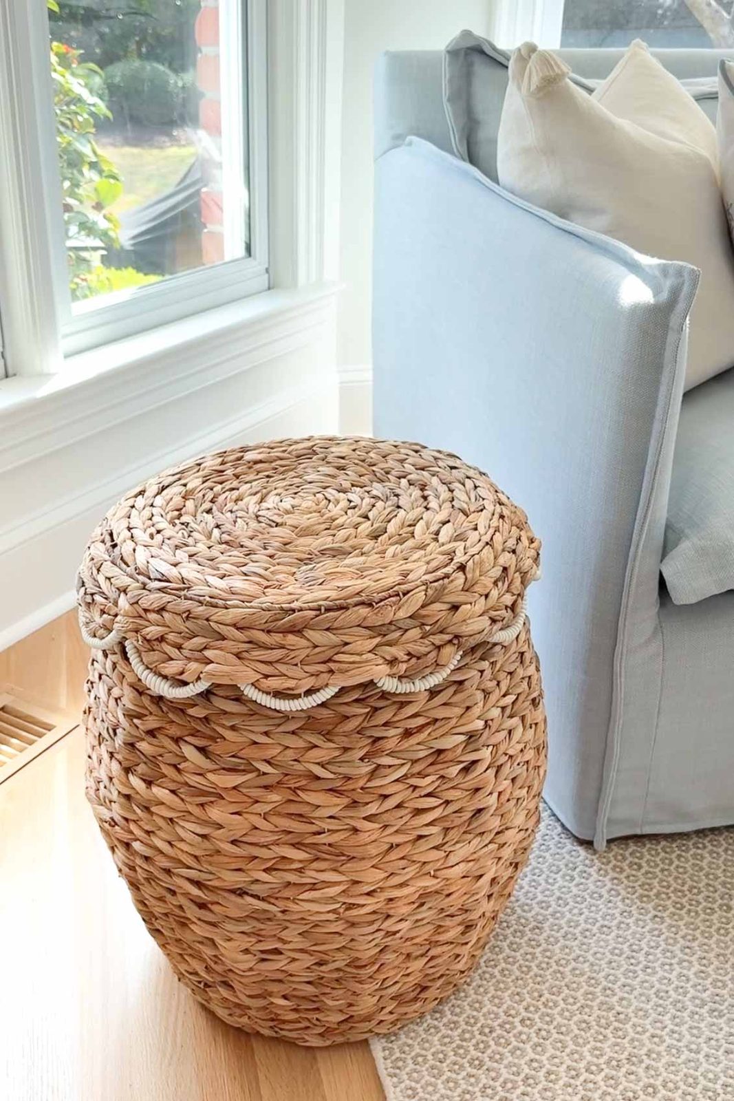 Scalloped lidded basket next to blue sofa