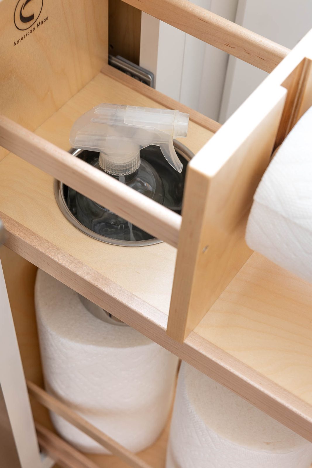 Spray bottle holder in kitchen paper towel pull-out