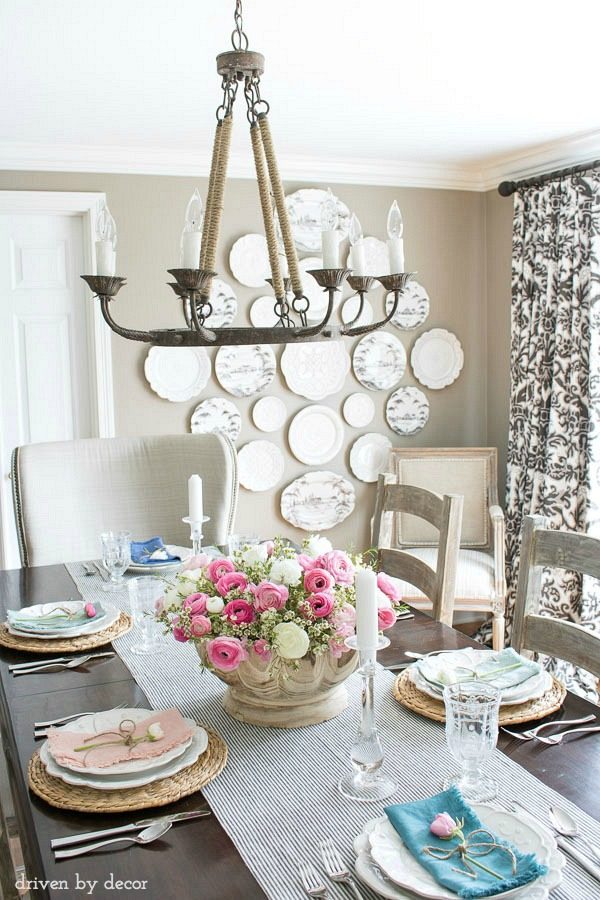 Spring dining room - love the simple centerpiece of a scalloped wood bowl filled with flowers. And the colorful napkins with a single flower on each plate is perfect!