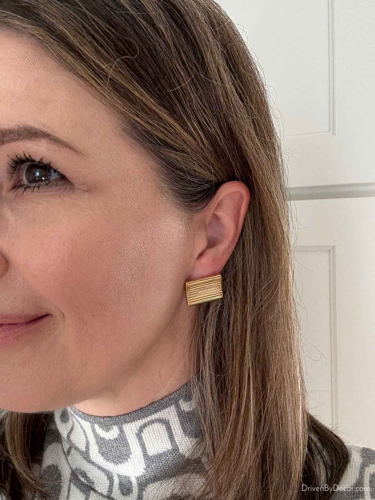 Wearing textured gold rectangle earrings