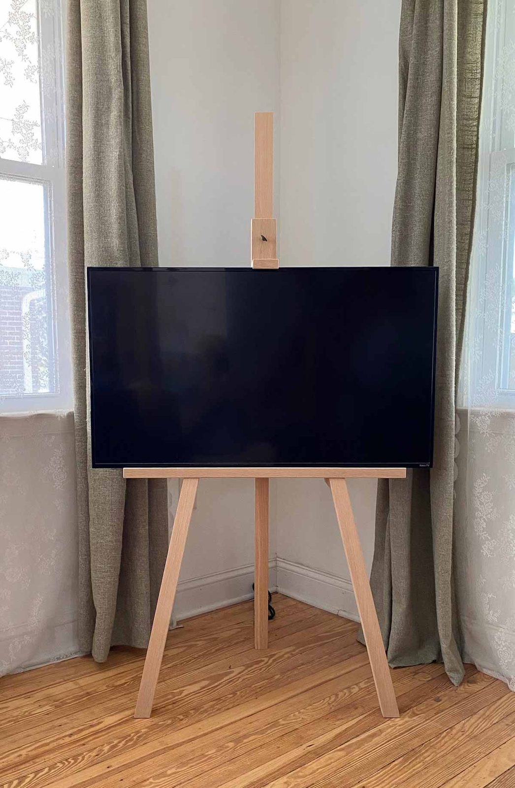 Wood TV easel in living room corner