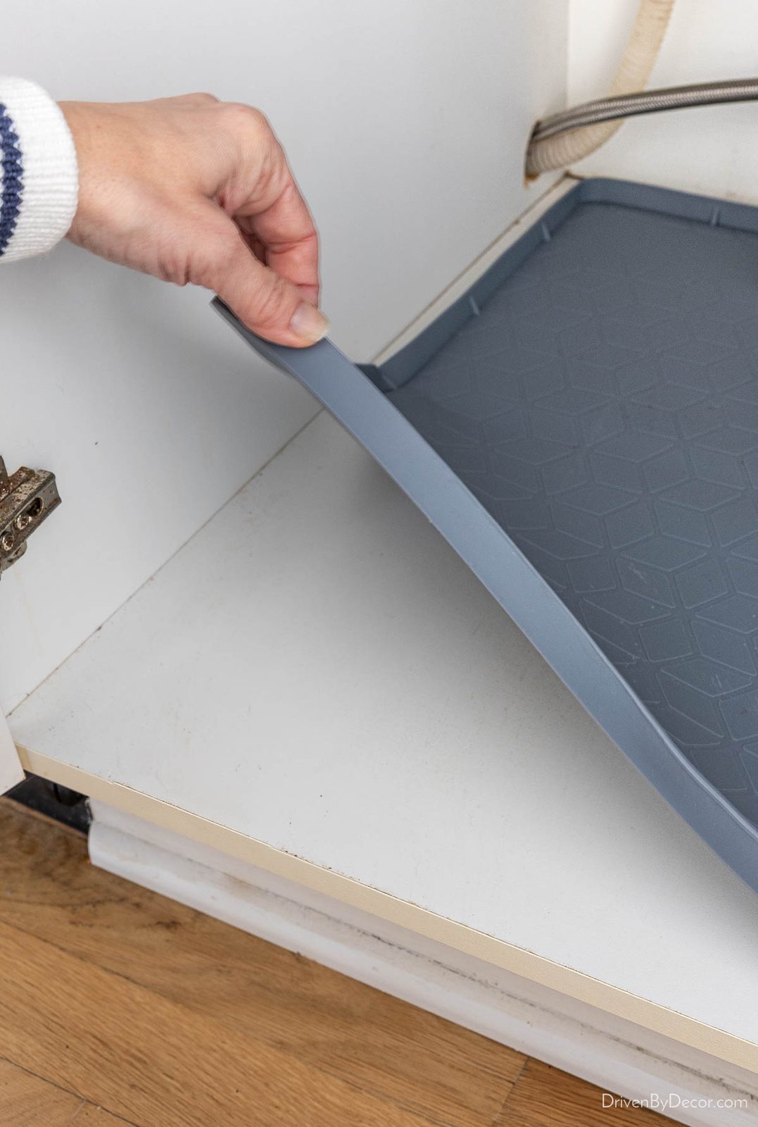 Gray silicone liner in kitchen sink cabinet