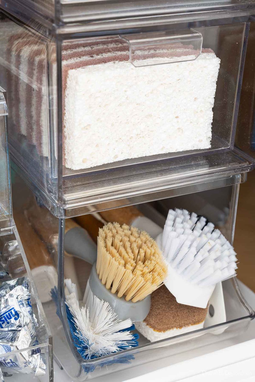 Acrylic drawers stacked on can organizer holding scrub brushes