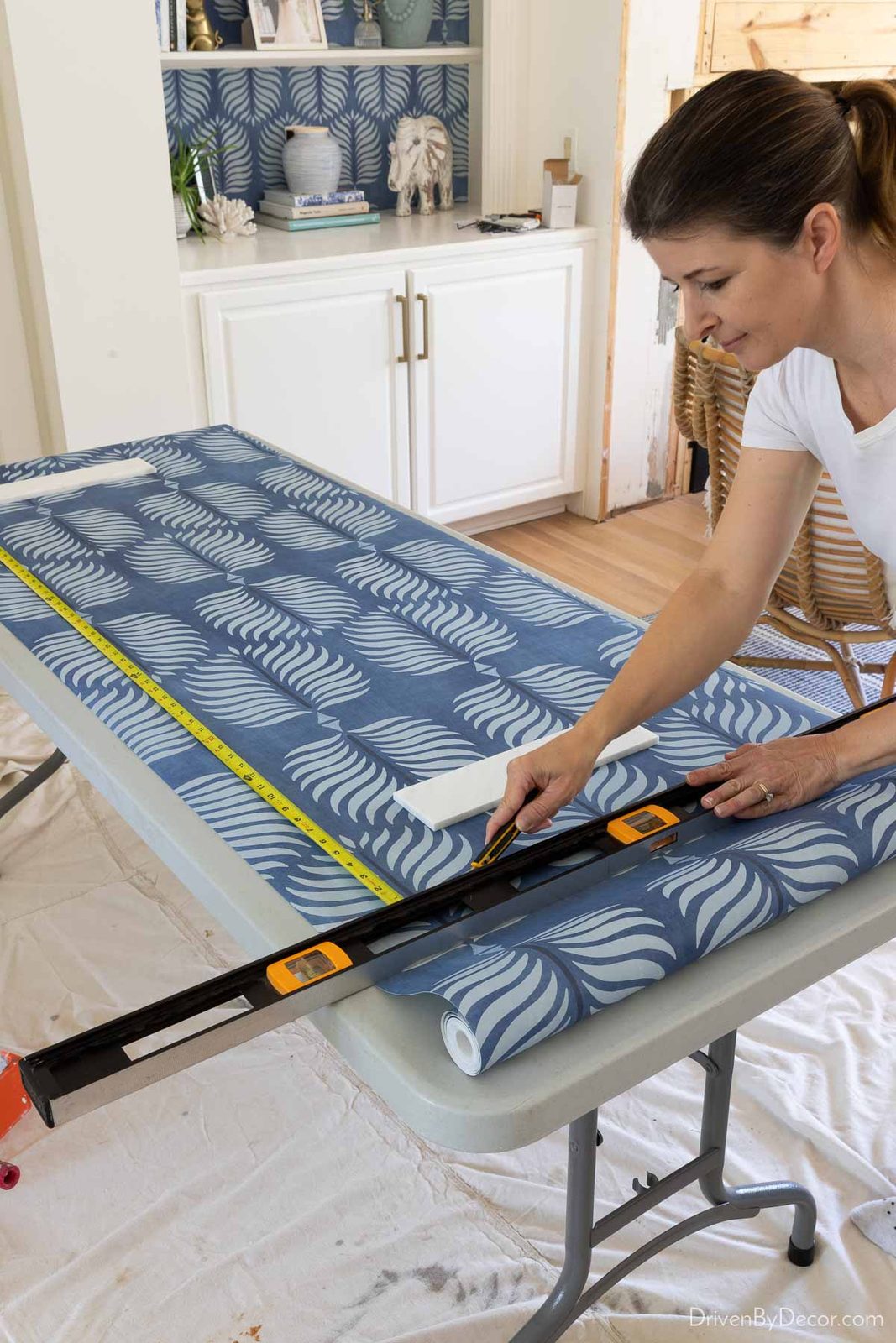 Measuring and cutting wallpaper strip