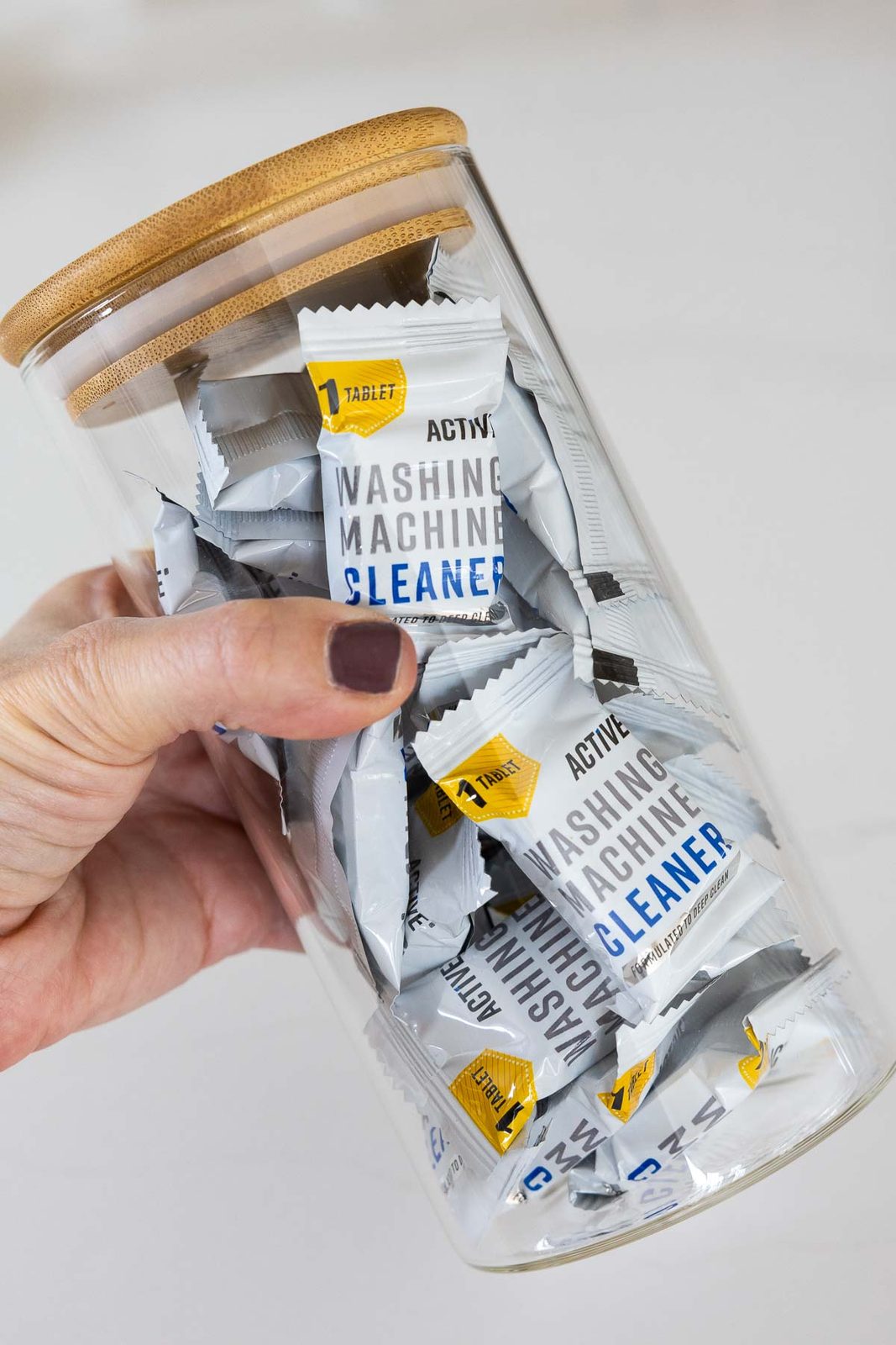 Storage container with washing machine cleaning tablets