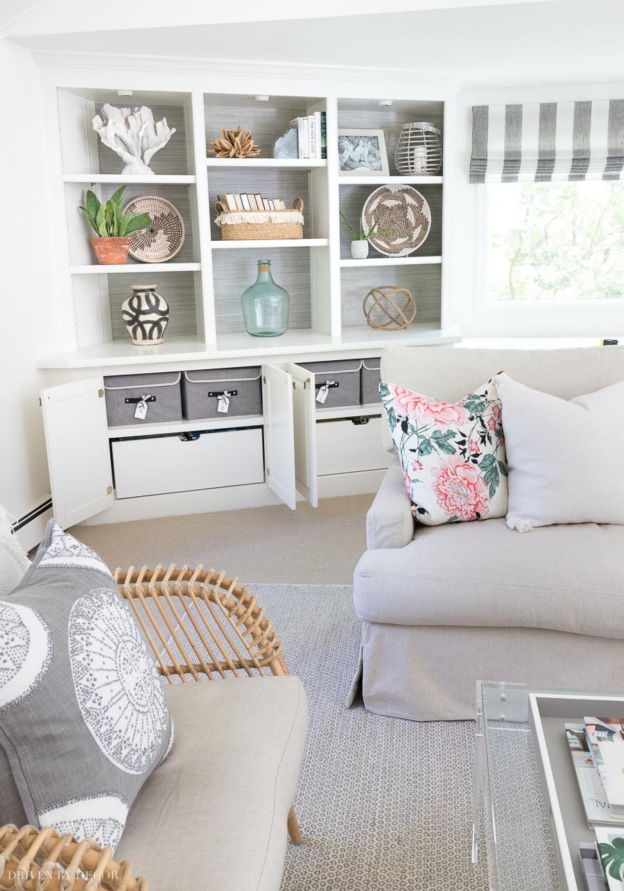 These lidded storage boxes for my pillow covers fit perfectly in the cabinets of our family room bookcase!