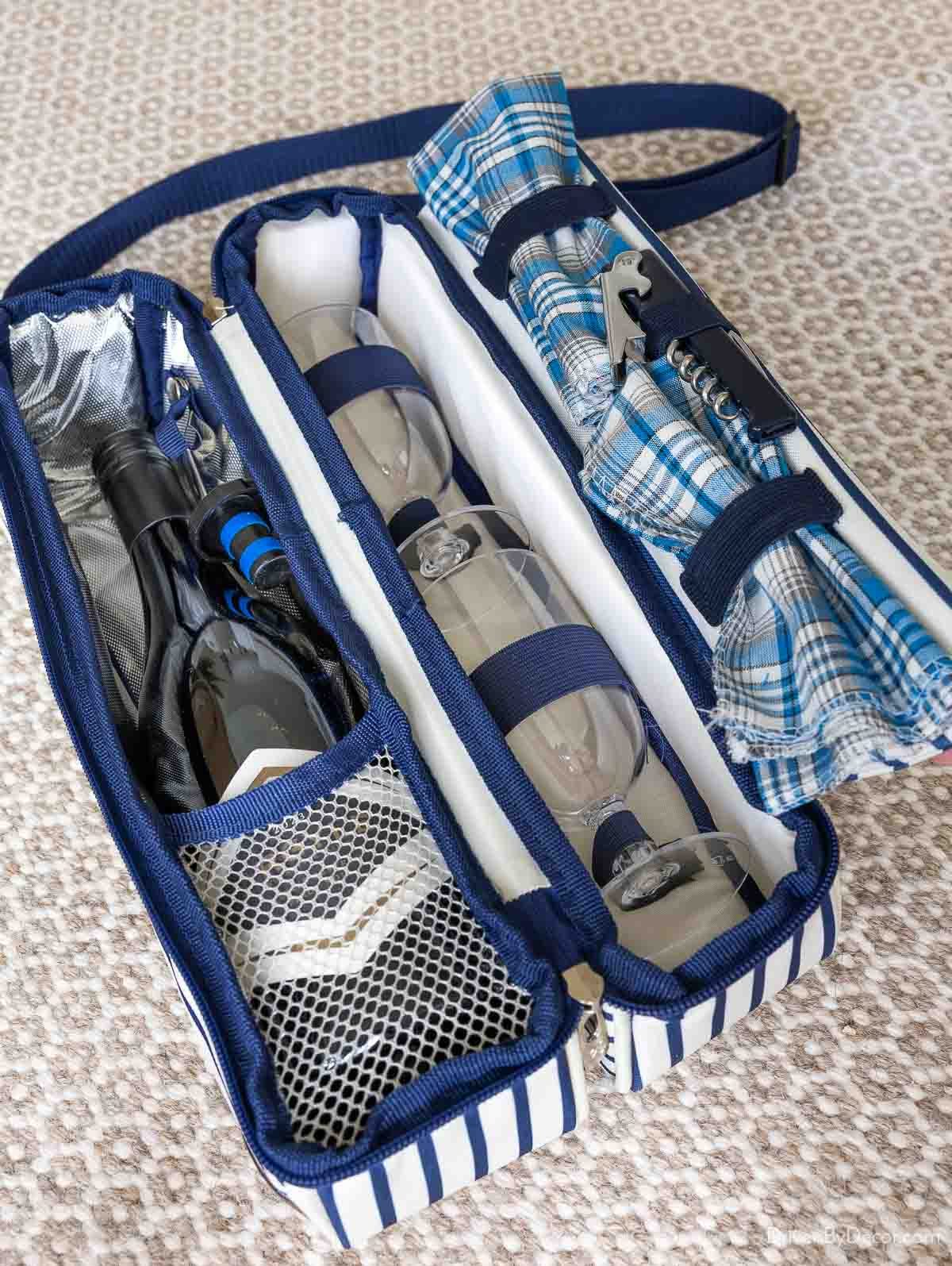 Wine tote with holders for wine bottle, glasses, an opener, and napkins