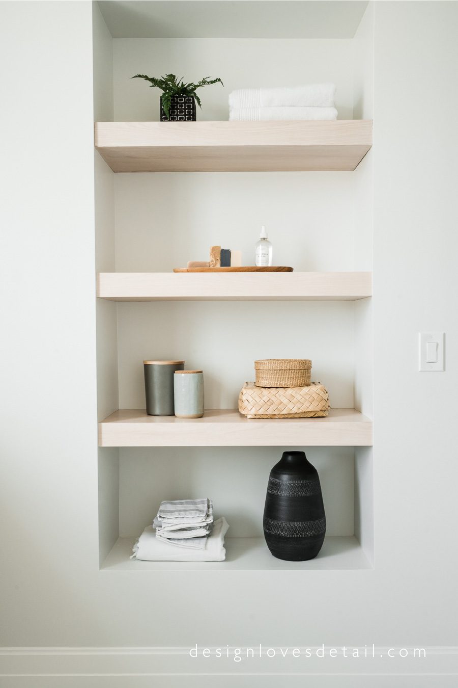 Gorgeous wood shelving in a bathroom designed by Mollie of Design Loves Detail