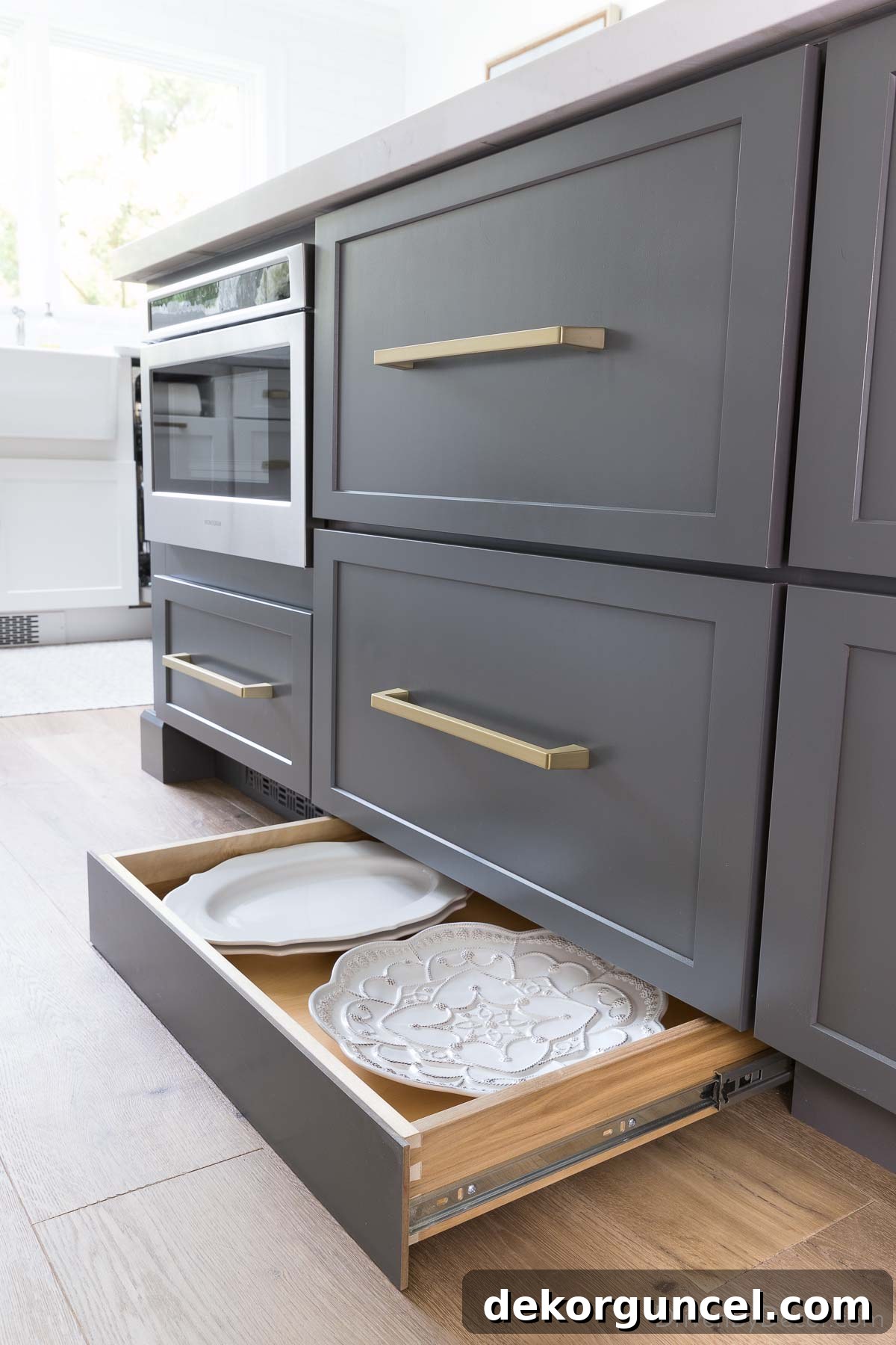 Toekick drawer in kitchen island for extra storage of large flat items