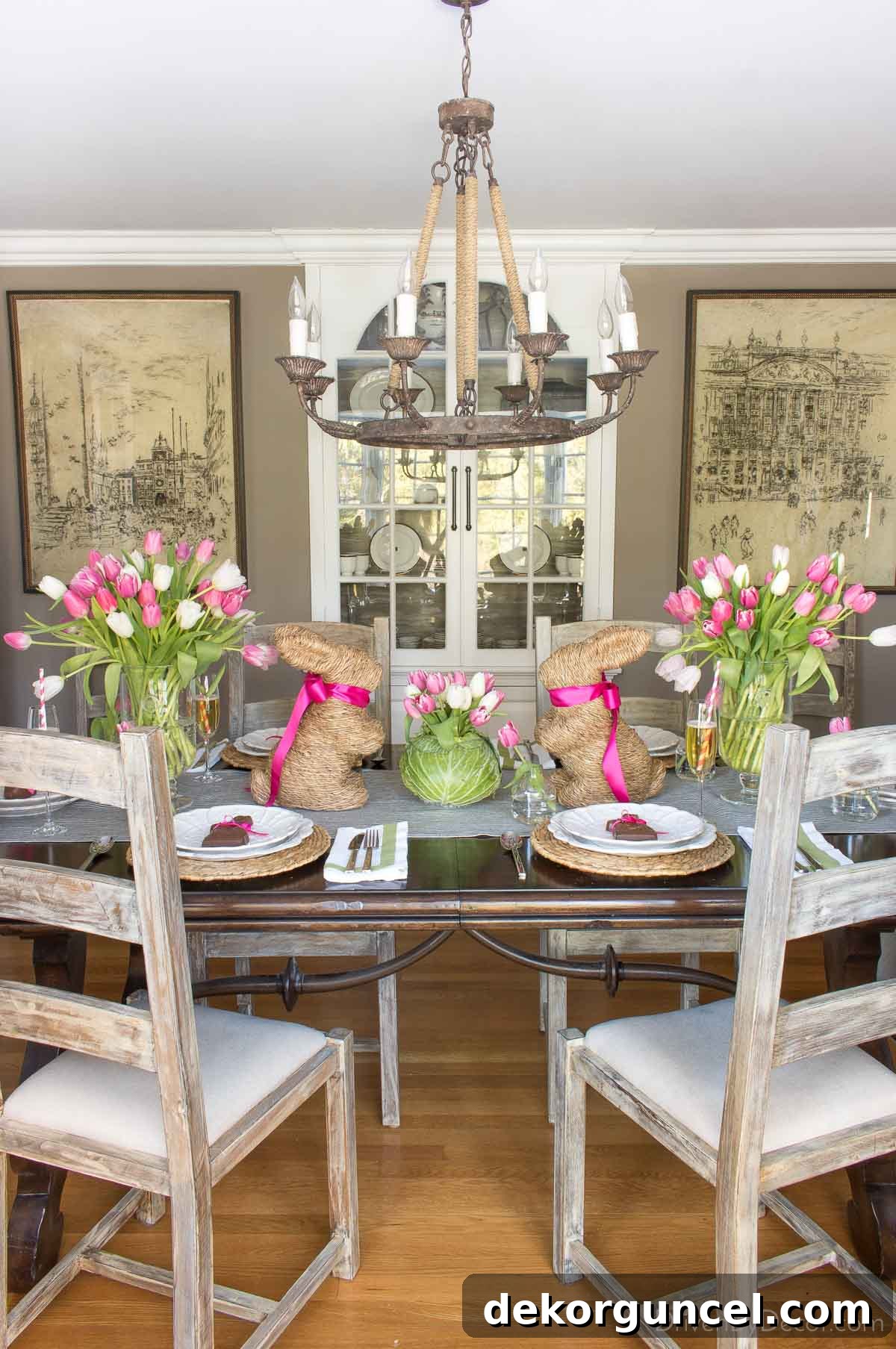 Charming centerpiece arrangement featuring festive bunnies nestled among vibrant bunches of fresh tulips, creating a delightful Easter display.