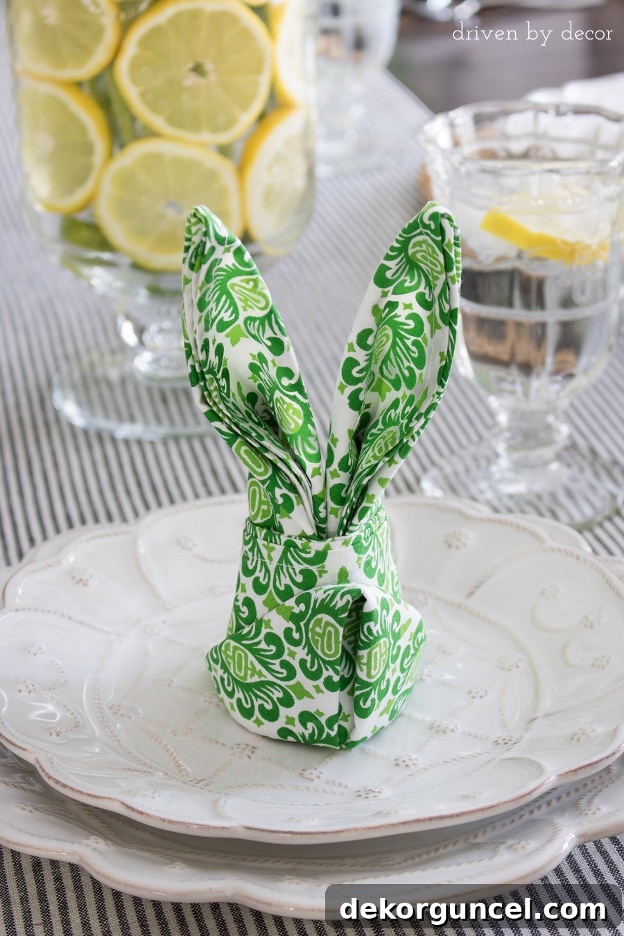 The cutest and simplest table decorations for Easter: neatly folded napkins shaped like bunny ears, adding a whimsical touch to each place setting.
