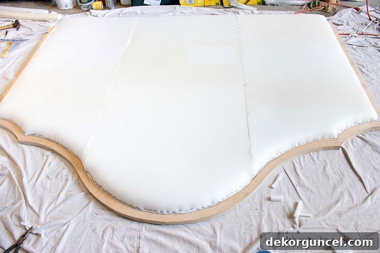 Build Your Own Banquette Seating 6 Foam stapled to plywood headboard, ready for upholstery and decorative nailhead application.