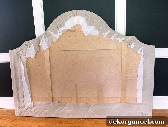 Build Your Own Banquette Seating 7 Back of upholstered headboard, showing fabric stapled and trimmed.