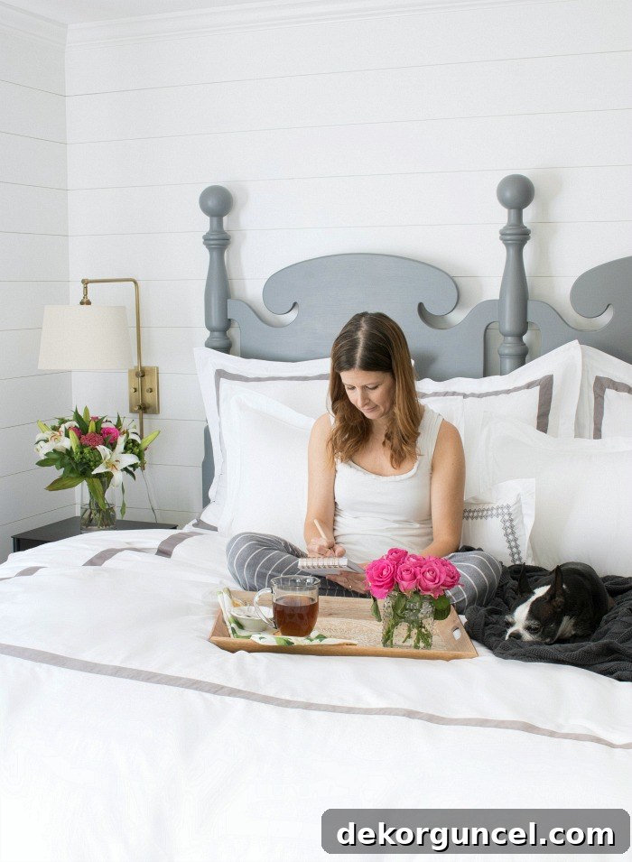 Beautifully made bed with Boll & Branch banded duvet and shams, ready for the day, showcasing a serene bedroom environment.