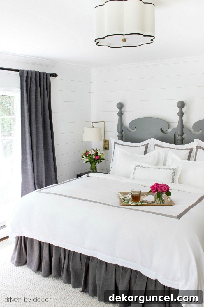 Elegant white and stone banded duvet cover and shams from Boll & Branch, creating a hotel-like aesthetic.