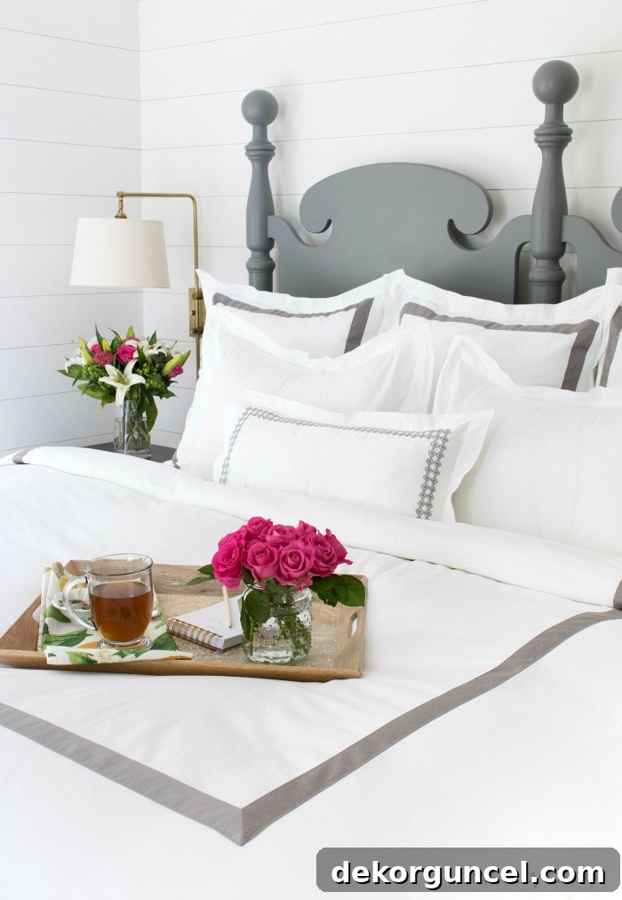 Detail shot of Boll & Branch banded euro shams and duvet cover with crisp edging, highlighting the quality and design.