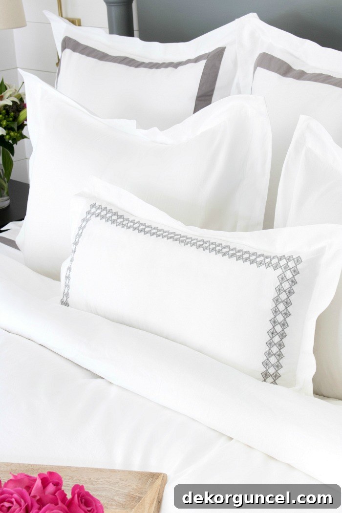 Close-up of Boll & Branch shams showing the quality and crisp details, along with the duvet cover and sheets.