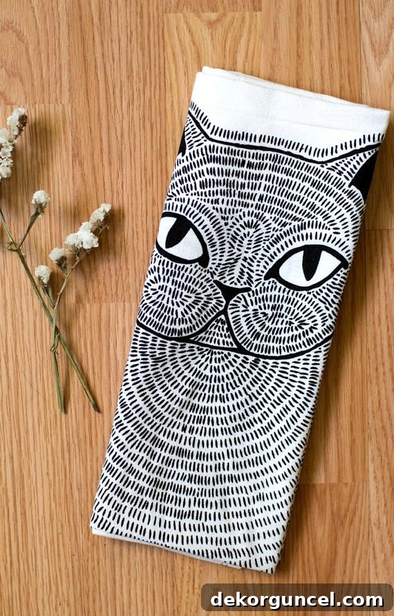 This elegant cat tea towel is a perfect component for a thoughtful hostess gift, adding charm and utility.