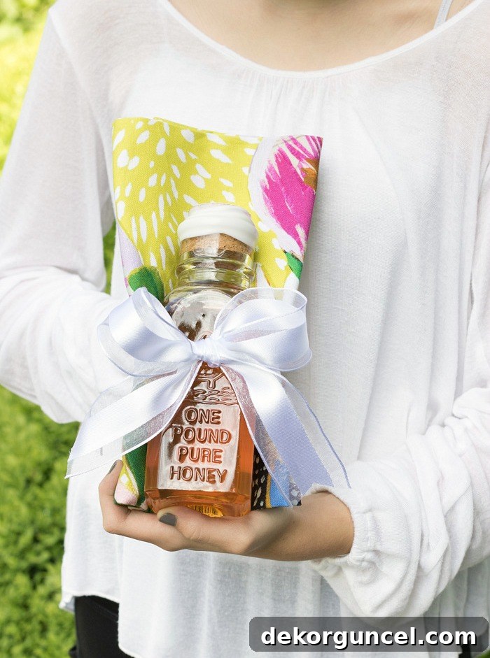 Simple Hostess Gifts That Impress 8 The perfect hostess gift: a beautiful tea towel bundled with a jar of local honey, combining practicality with a sweet treat.