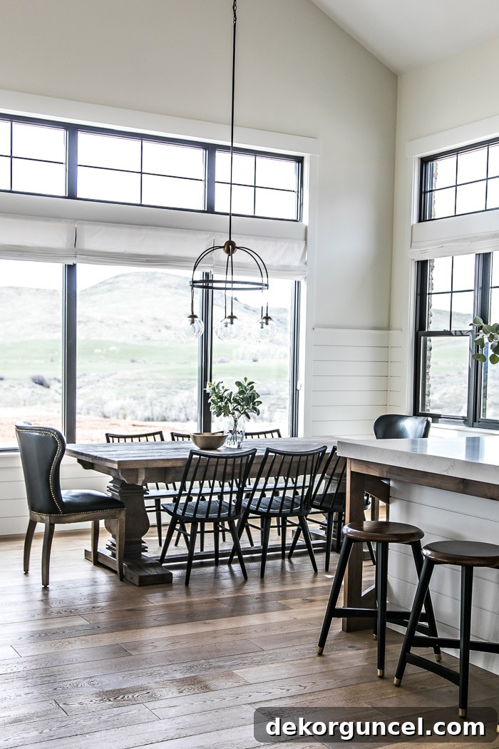 Eat-in dining area in modern farmhouse kitchen with pedestal table and black spindle chairs - Sita Montgomery Interiors
