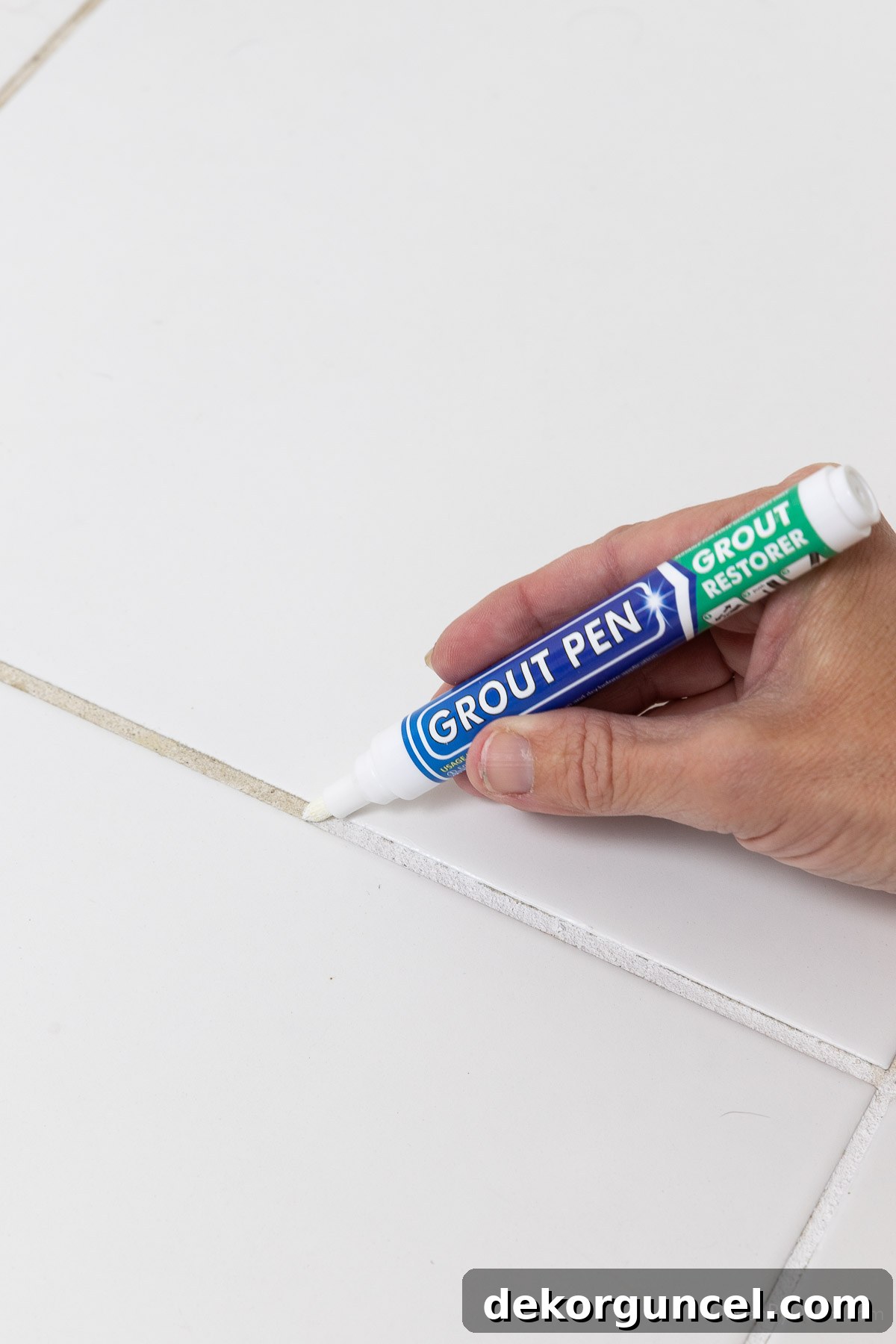 Using a grout pen to whiten grout