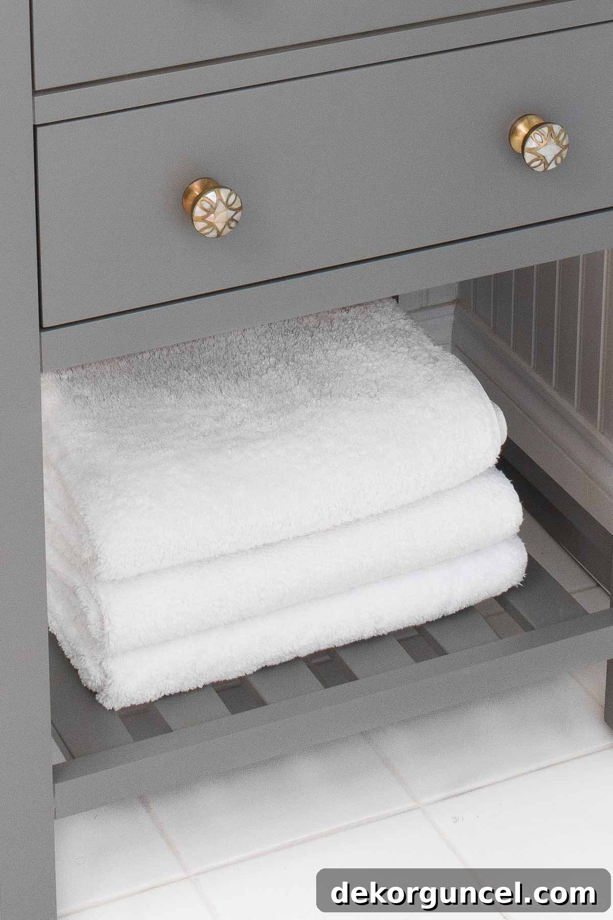 Guest bathroom towels on the shelf of our vanity