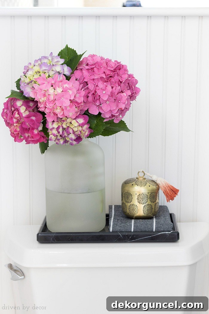 A black marble toilet tray is perfect for corralling a few accessories on top of the toilet tank!