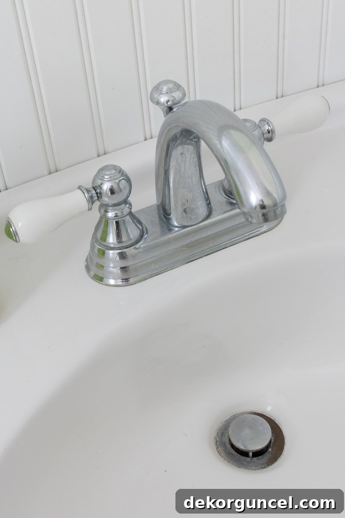 The "before": Our old ugly faucet and rusted drain - click through for the "after"!
