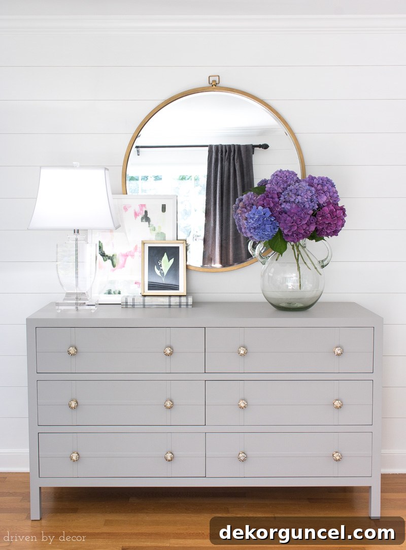 Purple hydrangeas in vase on bedroom dresser