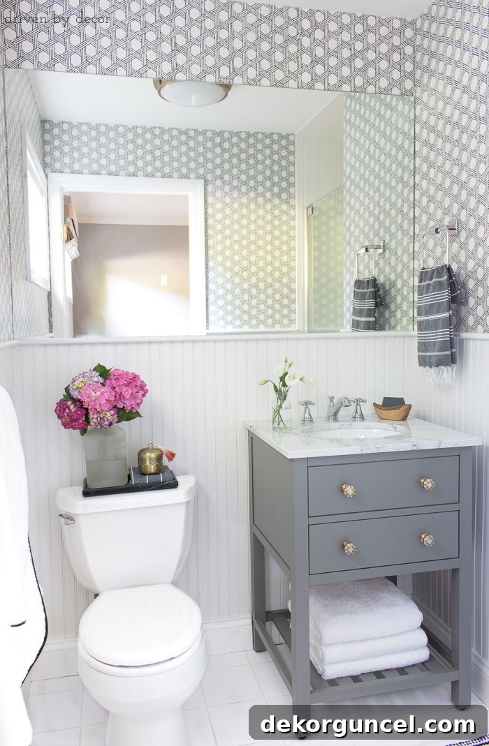 Bathroom Wallpaper The Verdict 3 Stylish guest bathroom remodel ideas: gray vanity, marble top, Delta Cassidy chrome faucet, and elegant wallpaper.