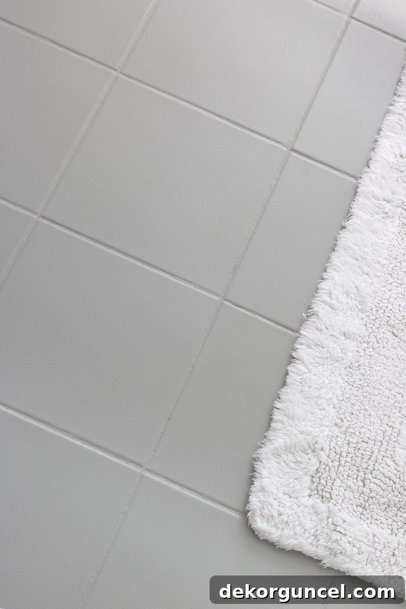 How to Paint a Tile Floor: Essential Tools and Proven Tips 10 Beautifully painted gray ceramic tile floor in a bathroom, showcasing a durable and refreshed surface that replaced an ugly original tile.