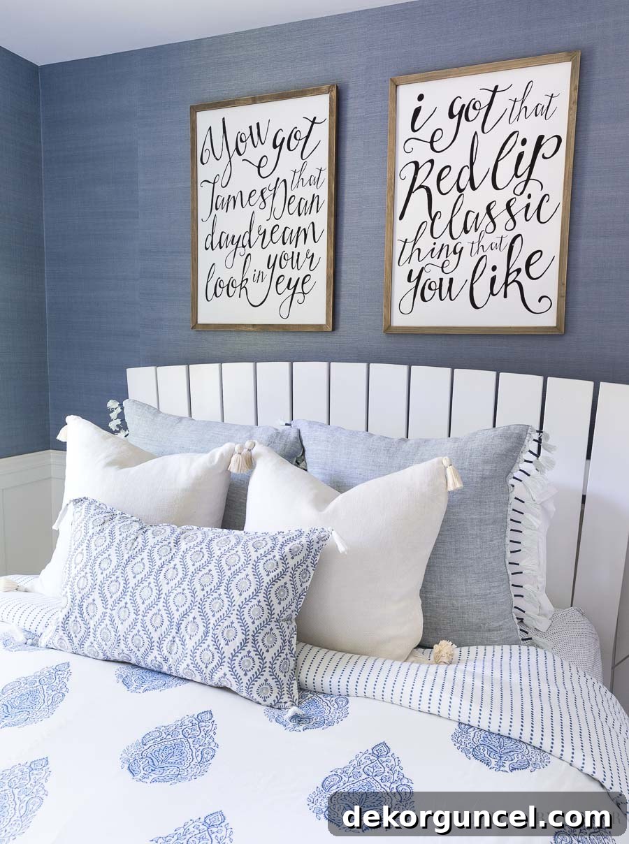 My Six Handpicked Kids Room Ideas 8 Showcasing a beautiful combination of blue and white pillows, including a patterned lumbar pillow, with personalized lyric art above the bed.