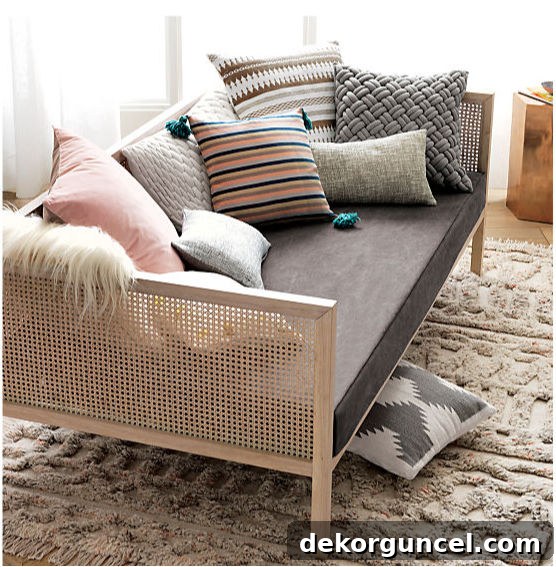 Boho daybed overflowing with a rich mix of colorful and textured pillows, creating an inviting lounge space for ultimate relaxation.