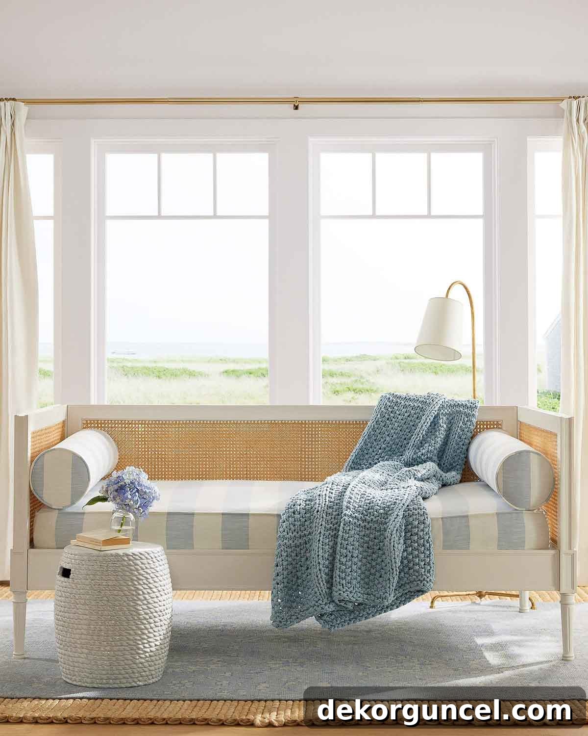 Stylish daybed creating an inviting reading nook with a modern floor lamp and a small side table for essentials, bathed in warm light.