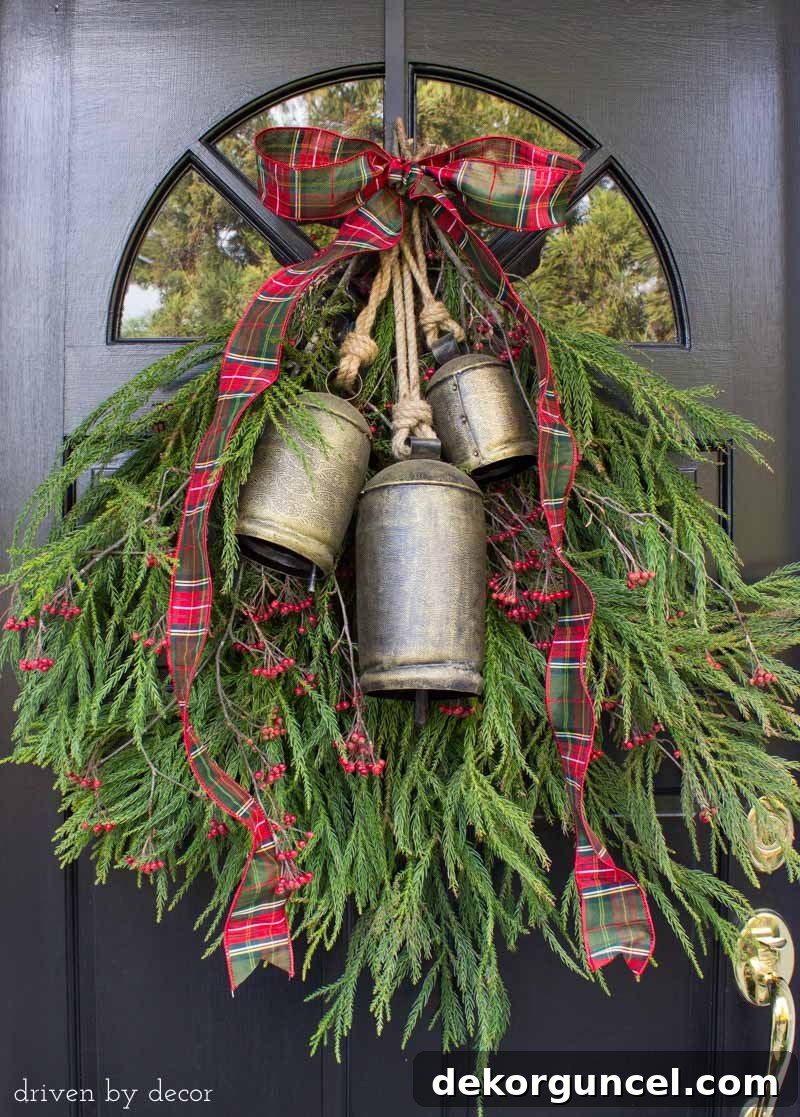 A simple greenery swag with bells to decorate your front door for Christmas - love!