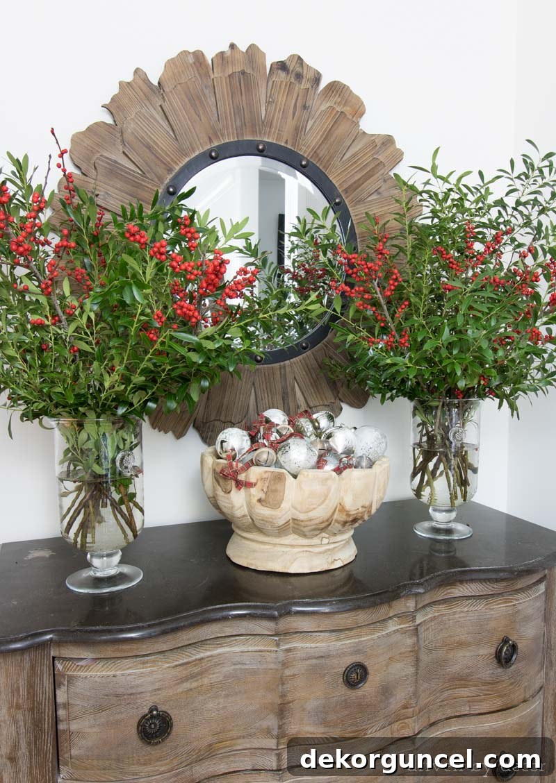 Branches clipped from backyard bushes plus berry bundles and a bowl full of ornaments make beautiful, simply entry way decor for Christmas.