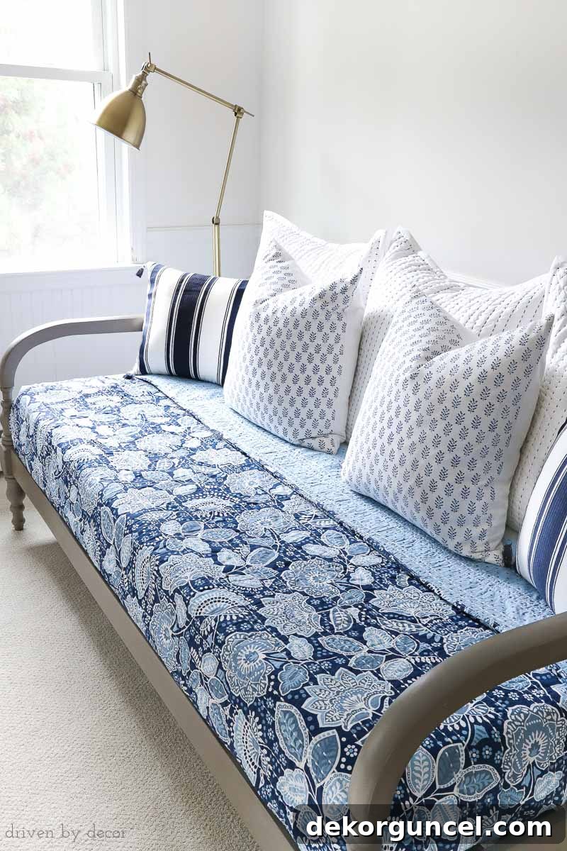 Excellent tips on how to begin decorating your bedroom, highlighting the lovely combination of colorful Vera Bradley bedding, a warm wood daybed, and a stylish brass floor lamp for a balanced look.