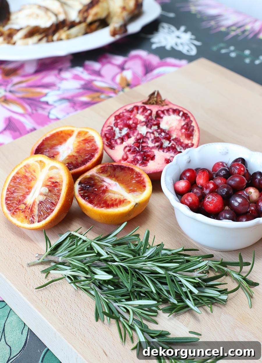 Pomegranates, blood oranges, cranberries, and fresh rosemary are used to dress up a rotisserie chicken. See more in the post!