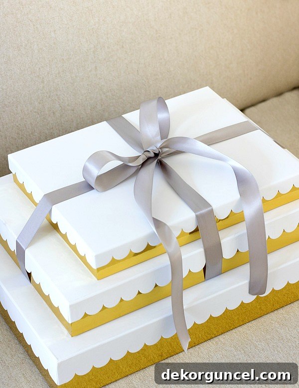 Elegant gold and white scalloped gift boxes tied with satin ribbon offer a beautiful, no-wrap solution for Christmas presents.