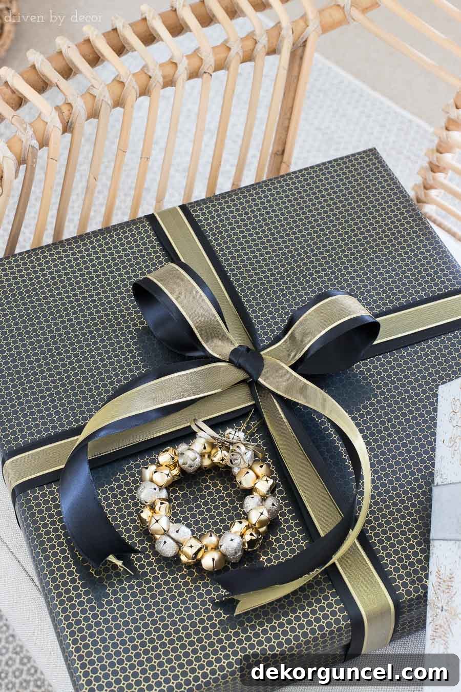 Layering a thin gold metallic mesh ribbon over a wide black satin ribbon creates a luxurious look for Christmas gift wrapping.