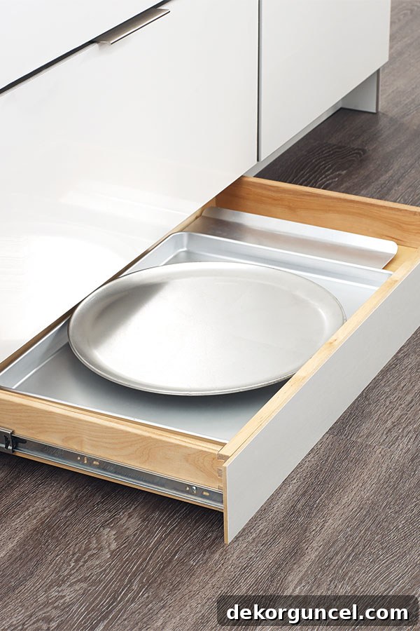 LOVE this toekick drawer - such a smart use of the bottom of your kitchen cabinets! Perfect for holding trays and cutting boards!