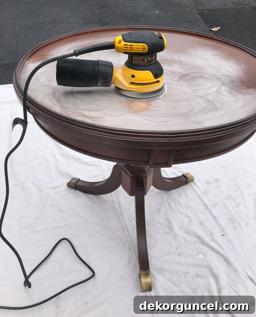 How to Refinish an End Table From Beat Up to Beautiful 3 Removing old finish and deep scratches from a wood veneer table with an orbital sander