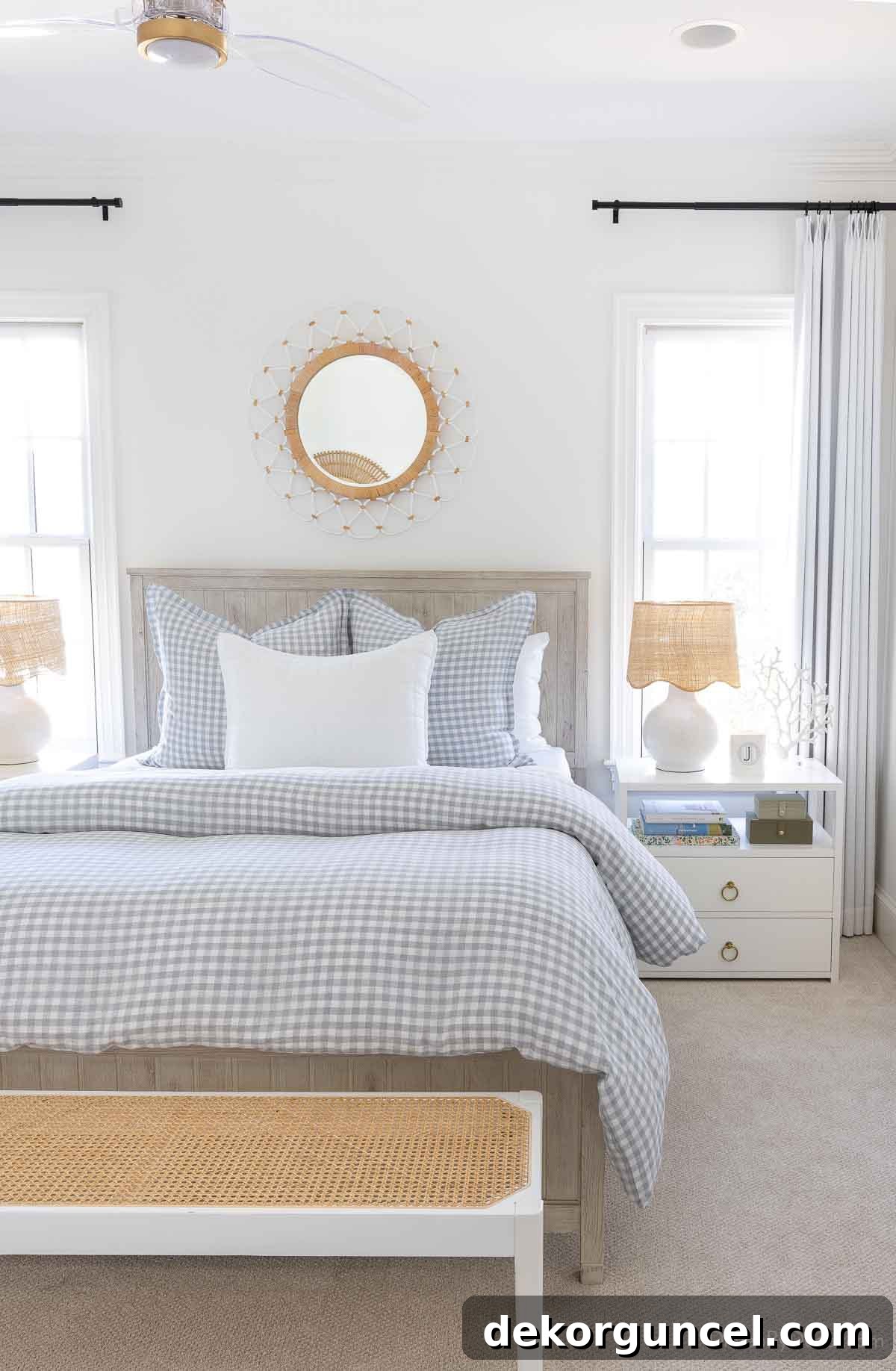 Woven round mirror above a queen bed