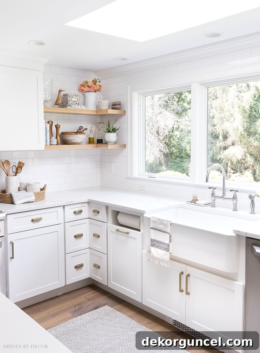 Our Kitchen Remodel: From Drab to Dreamy 20 A stunning view of our extended cabinet line along the long wall of windows, beautifully complemented by open wood shelving that gracefully wraps around the corner in our newly renovated kitchen.