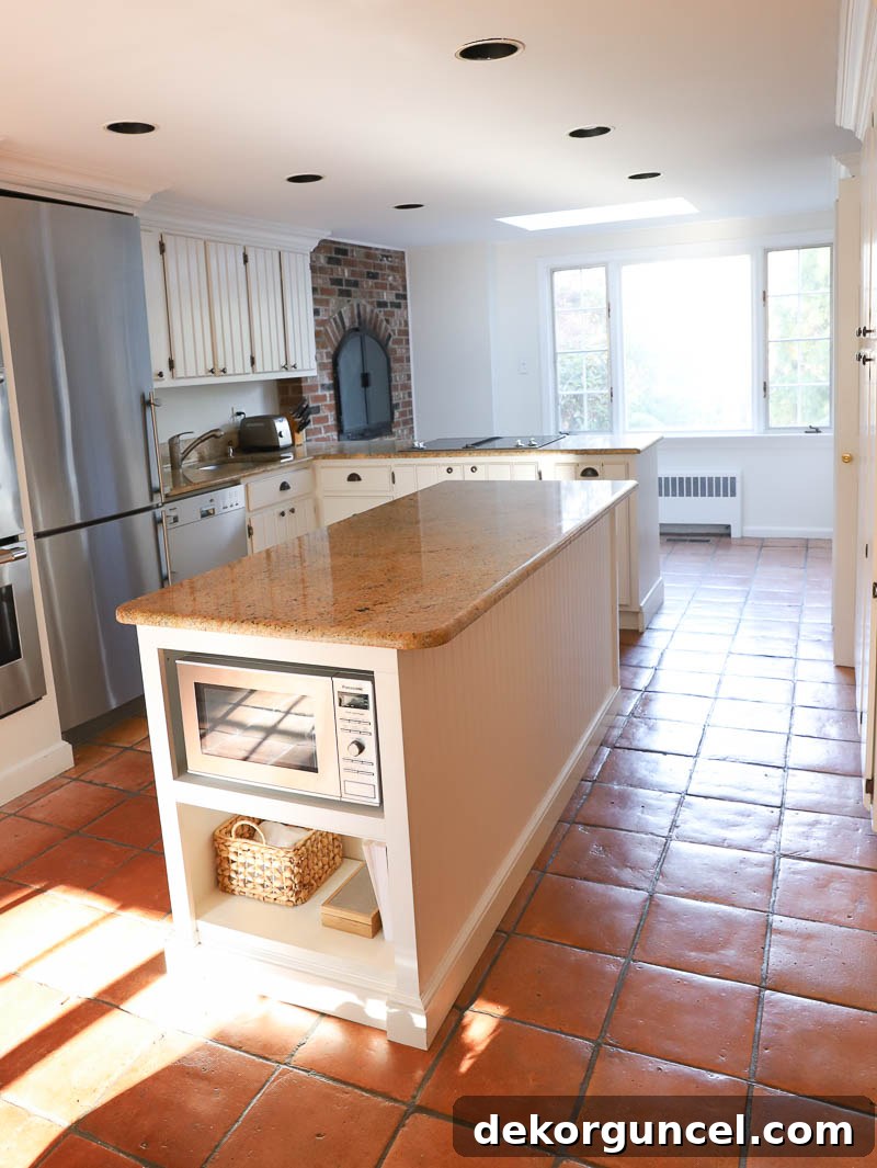 Our Kitchen Remodel: From Drab to Dreamy 3 Our kitchen's transitional phase before the major renovation, showing initial cosmetic updates like painted walls and no wallpaper.