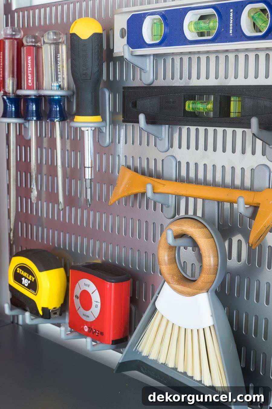 The smartest method to organize your most-used tools! This setup utilizes Elfa utility boards with various types of board hooks to neatly hold screwdrivers, levels, and other essentials.