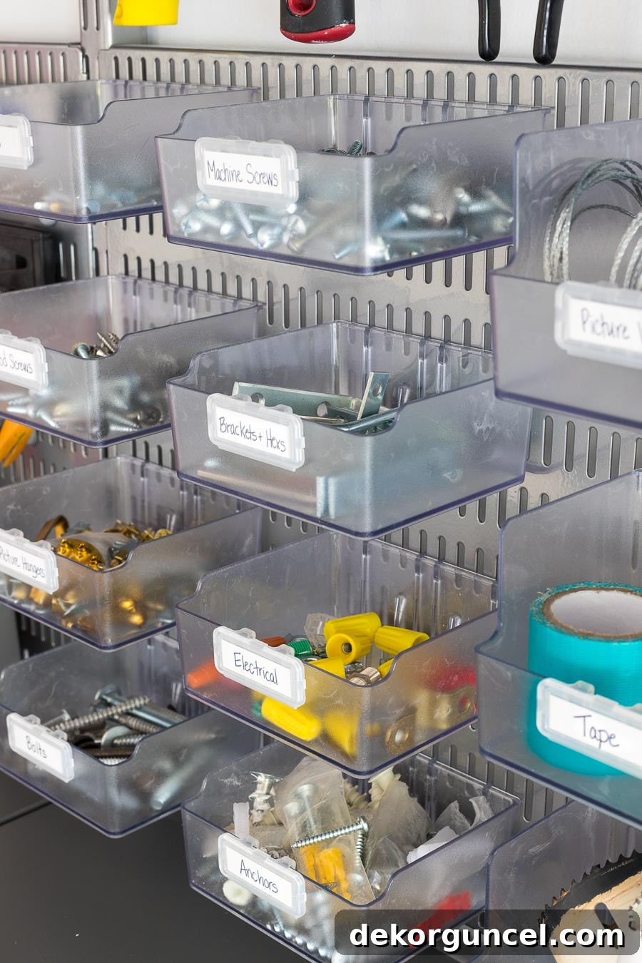 An excellent solution for storing small items like screws, picture hangers, and anchors! The clear bins attach securely to Elfa utility boards, achieving optimal garage organization.